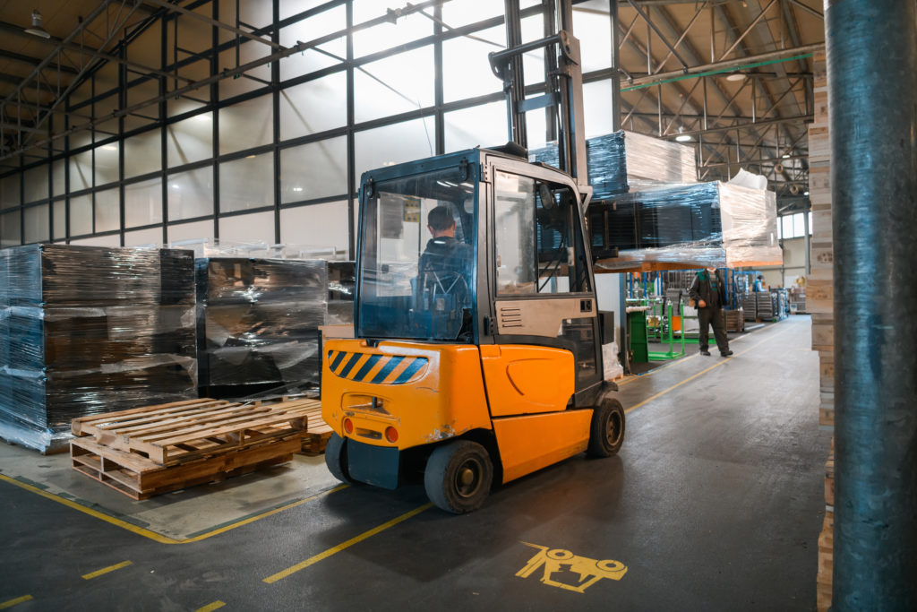 Forklift driving down clear picking path A clear picking path, avoiding another costly warehousing mistake.